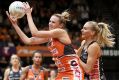 Collingwood's April Brandley puts pressure on the Giants' Jo Harten.