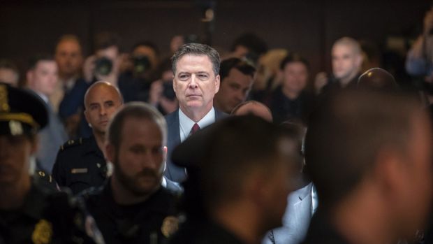 Former FBI director James Comey walks through a corridor on the way to a secure room to continue his testimony to the ...