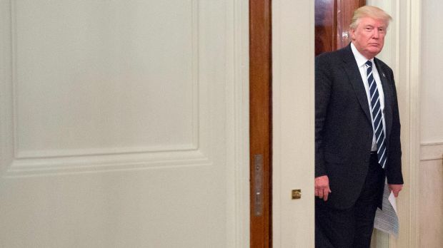 President Donald Trump walks into the State Dining Room of the White House on Thursday.