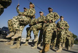 Hezbollah fighters parade during a ceremony to honor fallen comrades, in Tefahta village, south Lebanon, Saturday, Feb. 18, 2017.