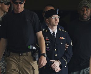 FOR USE AS DESIRED, YEAR END PHOTOS - FILE - Army Pfc. Bradley Manning is escorted out of a courthouse in Fort Meade, Md., Tuesday, July 30, 2013, after receiving a verdict in his court martial.