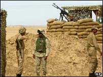 US soldier talks with an Iranian Mujahideen fighter