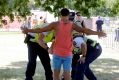 Police with sniffer dogs search people for drugs entering the Summadayze festival in Sydney.