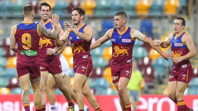 The Lions' Ryan Bastinac celebrates a goal with teammates in the big win over Fremantle.