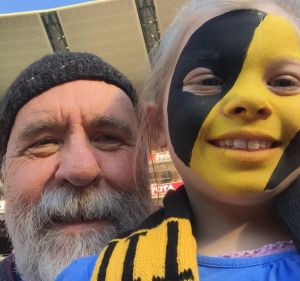 Martin Flanagan and his granddaughter Annie at the footy.