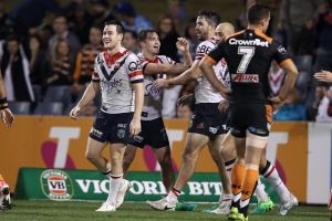 Too easy: Roosters player celebrate after Connor Watson's try.