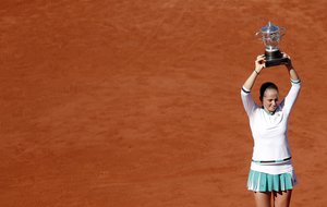 Latvia's Jelena Ostapenko holds the trophy after winning the women's final match of the French Open tennis tournament against Romania's Simona Halep in three sets 4-6, 6-4, 6-3, at the Roland Garros stadium, in Paris, France