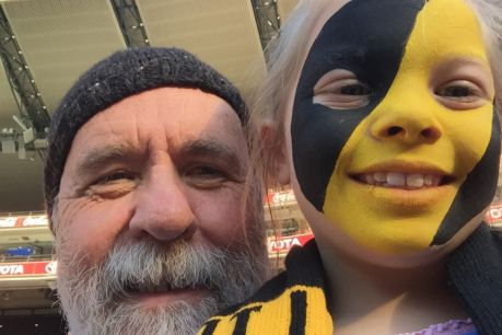 Martin Flanagan and his granddaughter Annie at the footy.