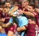 Holding on: Wade Graham of the Blues is tackled by Matt Gillett and Josh McGuire of the Maroons.