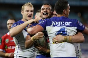 SYDNEY, AUSTRALIA - JUNE 12: Marcelo Montoya of the Bulldogs celebrates with his team mates after scoring a try during ...