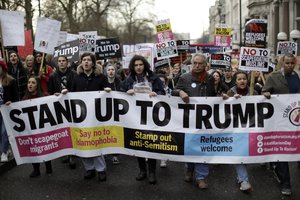 People hold a banner as they take part in a protest march in London, against U.S. President Donald Trump's ban on travellers and immigrants from seven predominantly Muslim countries entering the U.S., Saturday, Feb. 4, 2017.