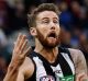 Collingwood's Jeremy Howe soars over Melbourne's Tom McDonald.