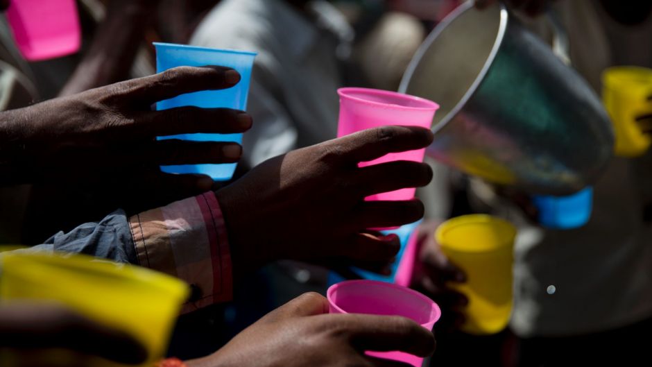 In this Monday, June 5, 2017, file photo, Indians reach to get a cold drink being freely distributed on a hot summer day ...