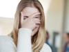 Cropped shot of a university student covering her face