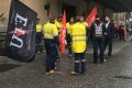 Electrical Trade Union members gather outside Brisbane City Hall on Tuesday.