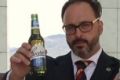 Liberal MPs Tim Wilson, left, and Andrew Hastie, right, hold up Coopers beer bottles in the video.