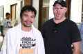 Working up a sweat: Manny Pacquiao with Andrew Webster after a training run on the streets of Manila.