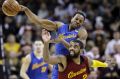 Cleveland Cavaliers' Kyrie Irving (2) and Golden State Warriors' Andre Iguodala (9) battle for a loose ball in last ...