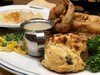 Fried chicken with gravy, mashed potatoes, scones, and side vegetables, served at a restaurant. Taken on April 2017.