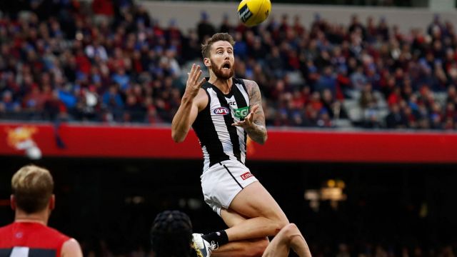 Jeremy Howe of the Magpies marks the ball over Tom McDonald of the Demons. 