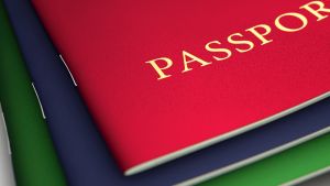 A stack of generic passports on an isolated white studio background