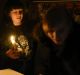 Street side cafe employees light a candle, after a power failure, in Simferopol, Crimea, Sunday, Nov. 22, 2015. Russia's ...