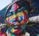 People wait for a tram next to the famed mural painted by artist Eduardo Kobra for the Rio 2016 Olympic Games in Rio de ...