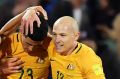 Tomi Juric, Aziz Behich and Aaron Mooy congratulate Tom Rogic after he scored the winner in the 2018 FIFA World Cup ...