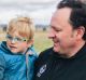 Paul Dowden and his three-year-old son Sebastian enjoy the horses on the Majura Road property Springfield on Friday.