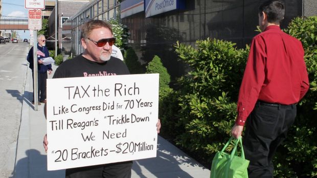 The suspected assailant, James Hodgkinson, pictured in 2012 protesting outside of the United States Post Office in ...