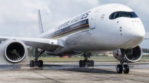 Airport firefighters, not pictured, perform a water salute for an Airbus SE A350 aircraft, operated by Singapore ...