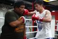 Manny Pacquiao hits the pads with Buboy Fernandez. By the end, the trainer is drenched in as much sweat as the fighter.