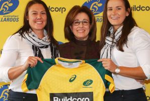 Wallaroos stars Sharni Williams (left) and Shannon Parry (right) with Buildcorp's Josephine Sukkar. 