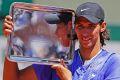 Australia's Alexei Popyrin hold the trophy after winning his boys' final match of the French Open.