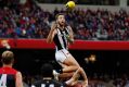 Jeremy Howe of the Magpies marks the ball over Tom McDonald of the Demons. 