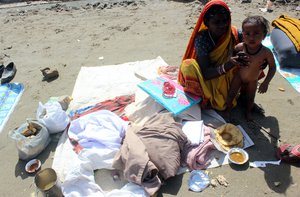 File - A women and child begging for food and money in Jammu, India,  28 March, 2017.