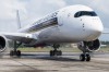 Airport firefighters, not pictured, perform a water salute for an Airbus SE A350 aircraft, operated by Singapore ...