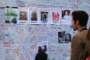 A man looks at a message wall near the Grenfell Tower block in London.