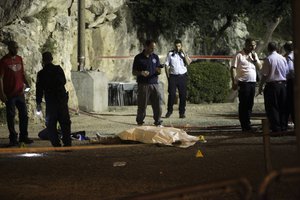 Israeli police stand around a body of a Palestinian in Jerusalem, Friday, June 16, 2017.