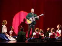 Baron Von Trapp (Nicholas Rodriguez) plays Edelweiss surrounded by his children in  The Sound Of Music .  Photo by Matthew Murphy.