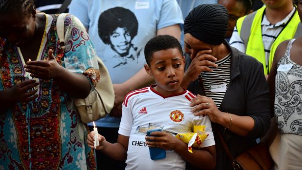 People attend a candlelight vigil outside Notting Hill Methodist Church near the Grenfell Tower block.