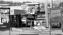 A black and white photo of lots of large signs in Fyshwick.