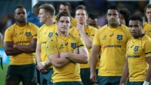 Wallabies captain Michael Hooper stands in front of his team-mates following the loss to Scotland.