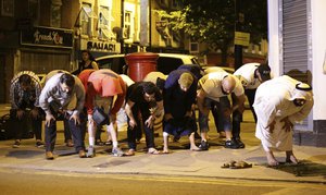 Local people observe prayers at Finsbury Park in north London, where one person has been arrested after a vehicle struck pedestrians, leaving "a number of casualties". PRESS ASSOCIATION Photo. Picture date: Monday June 19, 2017.