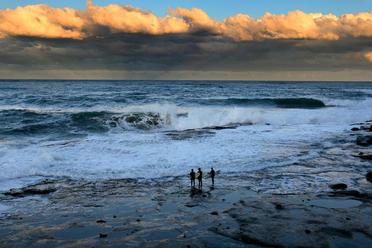 Three surfers waiting for the