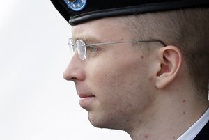 In this Tuesday, Aug. 20, 2013, file photo, Army Pfc. Bradley Manning, who now wishes to be known as Chelsea Manning, is escorted to a security vehicle outside a courthouse in Fort Meade, Md., after a hearing in his court-martial.