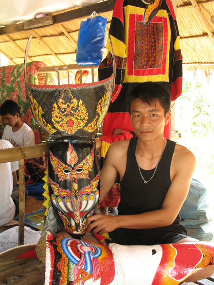 Wirayut Natsaengsri with two of his masks in Dansai village, Thailand, in 2006. Photo by Sunee Prasongbandit, Ralph Rinzler Folklife Archives 