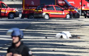 A body lies covered on the Champs Elysees avenue after a man rammed into a police convoy in Paris, Monday, June 19, 2017.