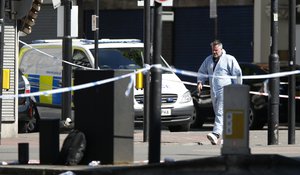 A forensic officer leaves the scene where a van struck pedestrians in Finsbury Park, north London, Monday, June 19, 2017.