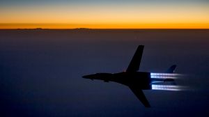 In this photo released by the US Air Force, a plane flies over northern Iraq after conducting airstrikes in Syria ...